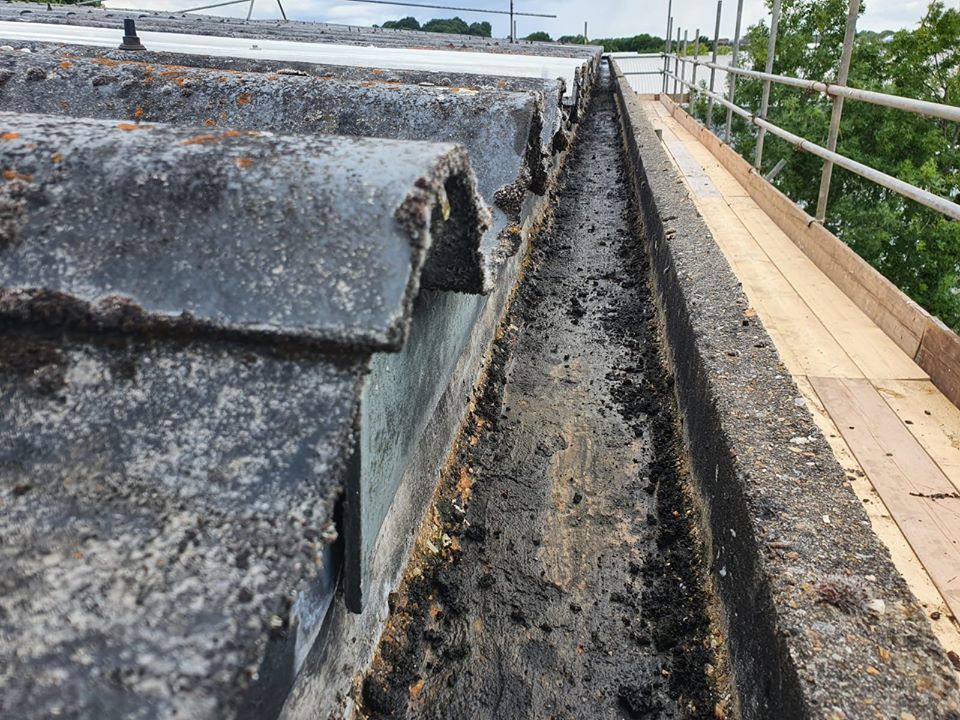 Gutter repair to warehouse and office roofs in Chessington Surrey