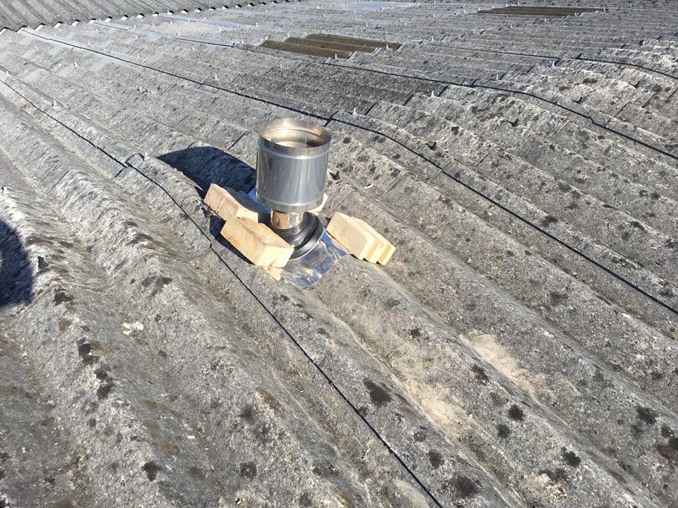 Pipe and Flue repair to a Warehouse Roof in Redhill Surrey