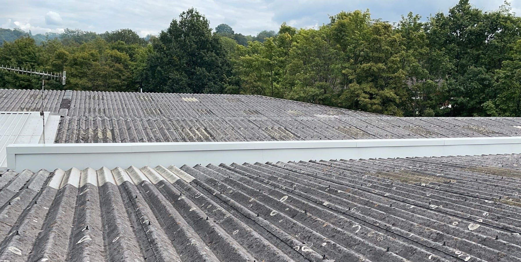 Leaking gutter on a warehouse and office roof in Crowborough East Sussex