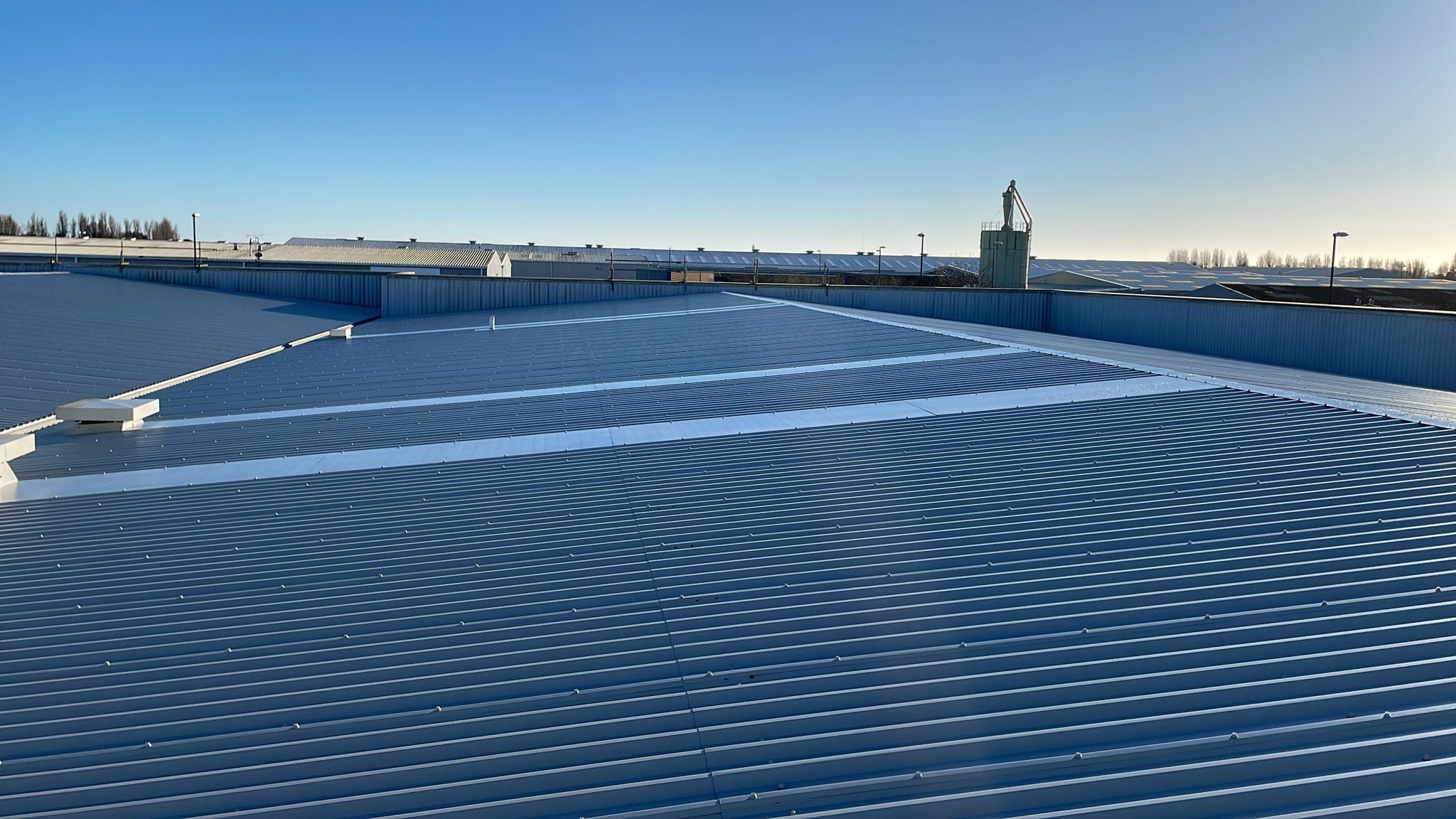 Over-roofing and rooflights to an office and workshop roof in Bognor Regis, West Sussex