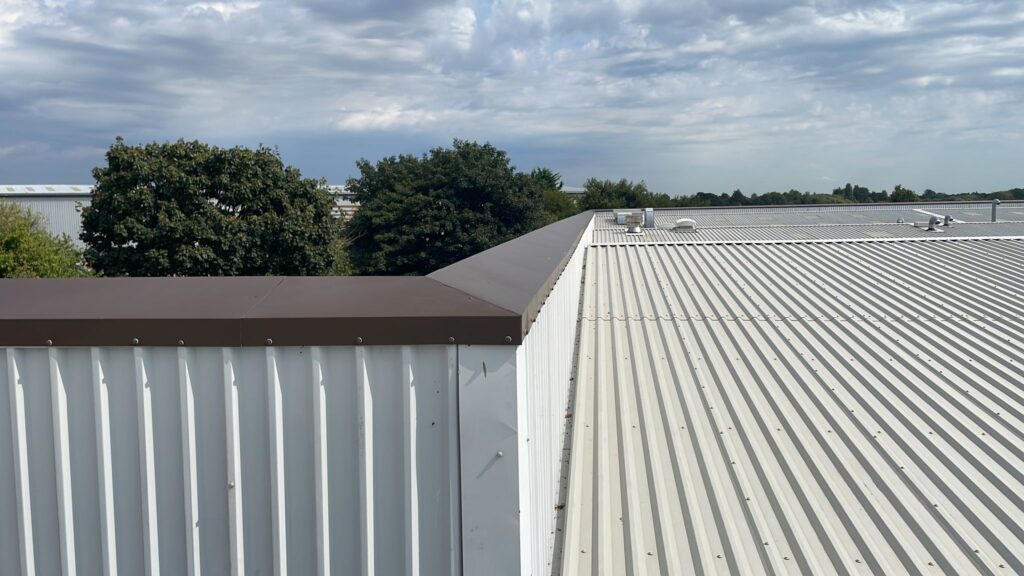 Parapet wall capping flashings on an office and workshop roof in Bognor Regis, West Sussex