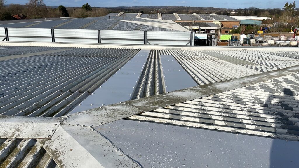 New ski-slope flashings were fitted to repair a warehouse roof in Salford, Redhill, Surrey