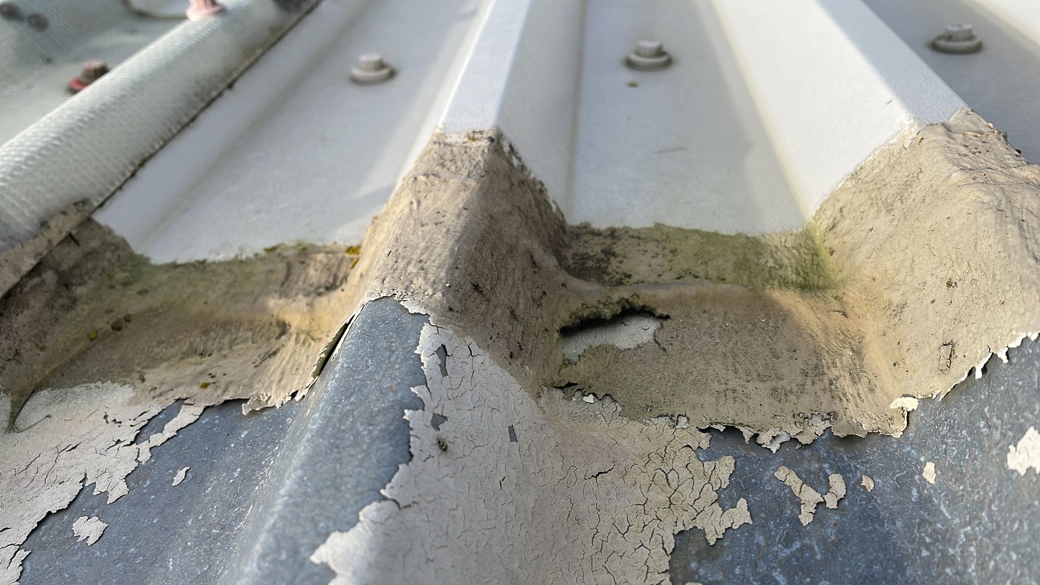 flashings were fitted to repair a warehouse roof in Salford, Redhill, Surrey