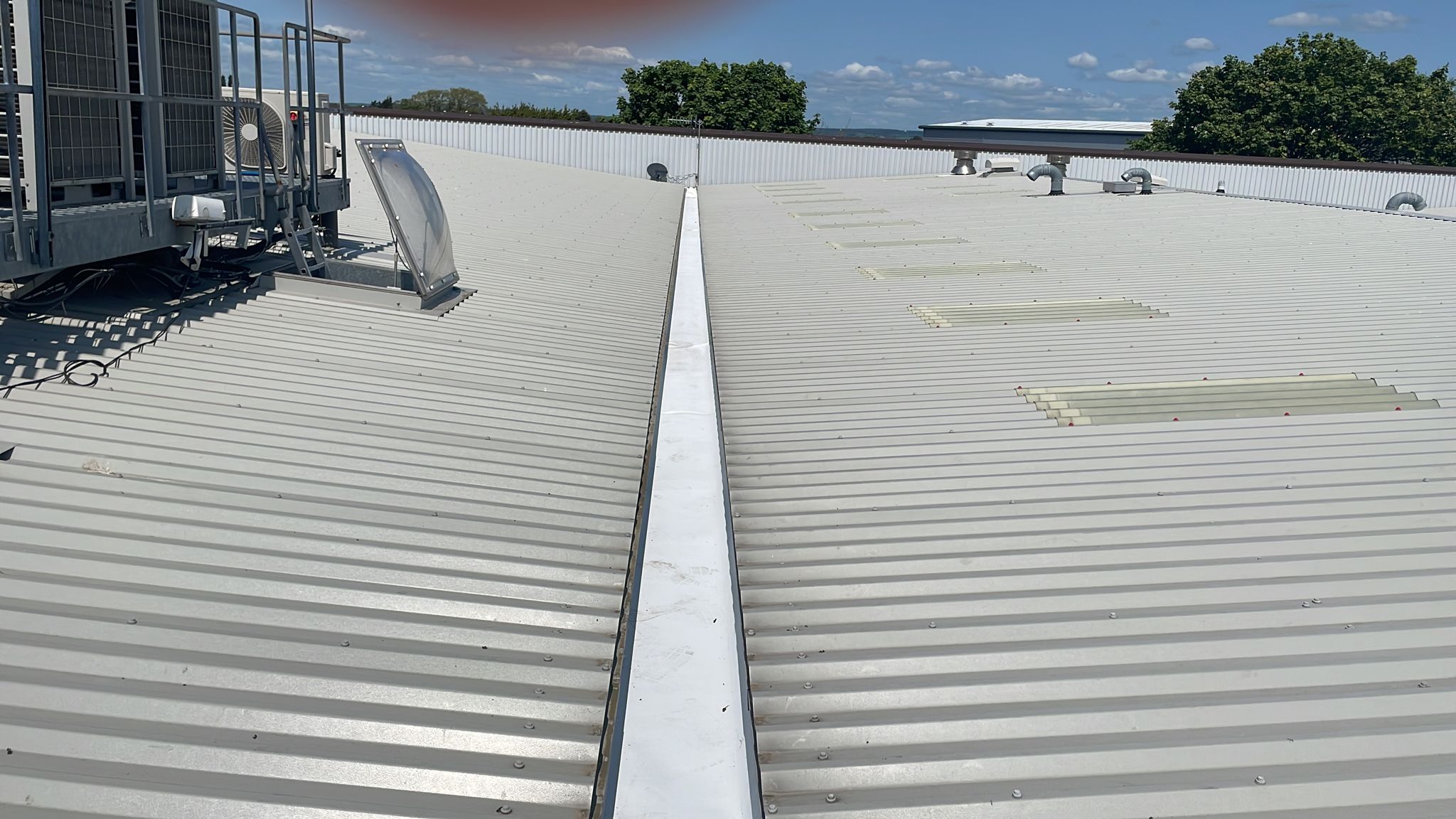 repairs to a gutter serving an office and workshop roof in Bognor Regis, West Sussex