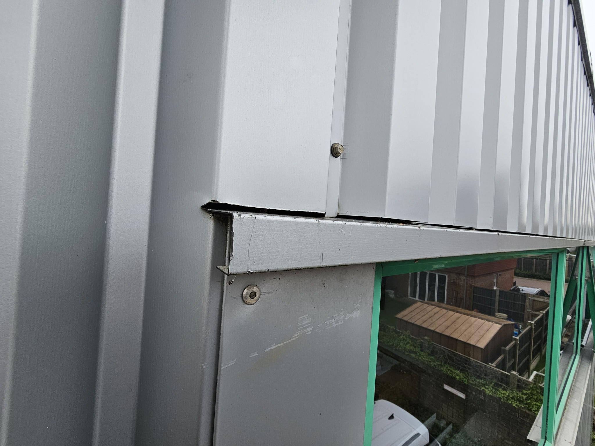 Cladding work to a gutter serving an industrial Unit in Tadworth, Surrey.