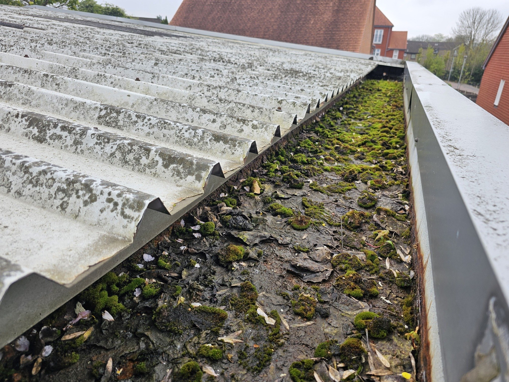 Repairs to a gutter serving an industrial Unit in Surrey.
