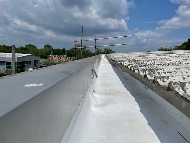 Repairs to a gutter serving an industrial Unit in Tadworth, Surrey