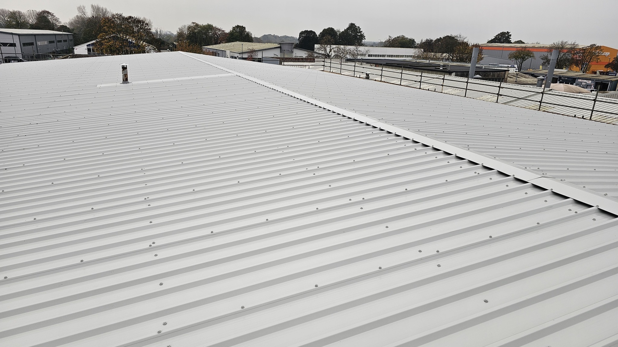 Over-roofing and roof repairs to an office and workshop roof in Chichester, West Sussex